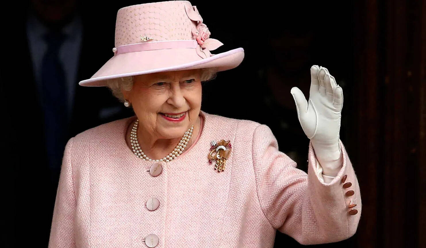 Queen Elizabeth II Waves To Crowds While Departing Manchester Town Hall In Northern England
